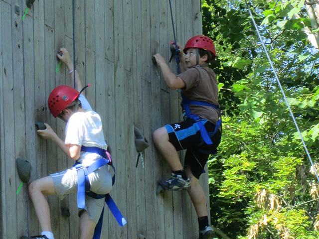 Hiram House campers climbing a wall