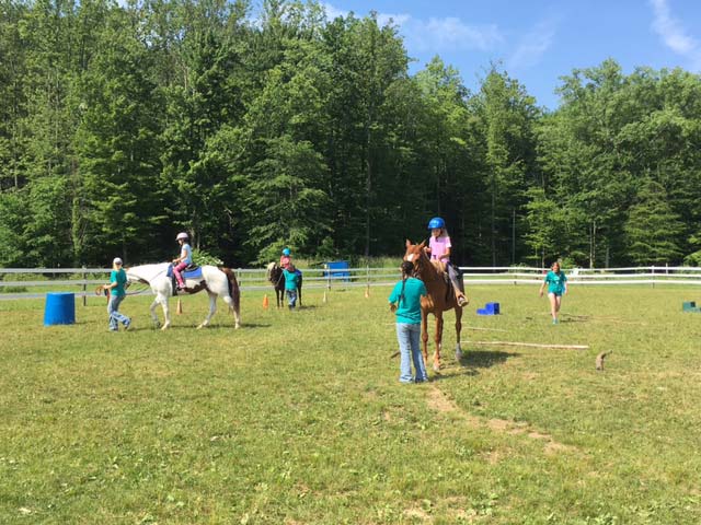 Hiram House instructors teaching horseback riding