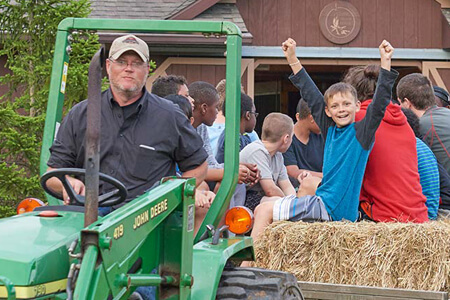 Children on hay ride pulled by tractor